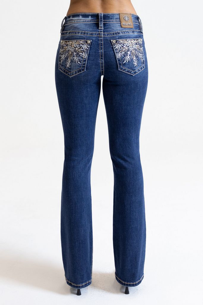 A pair of women's mid-rise blue jeans with floral pocket embellishments and a bootcut leg design.