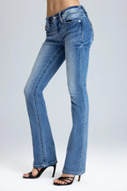Blue jeans worn by a person on a white background