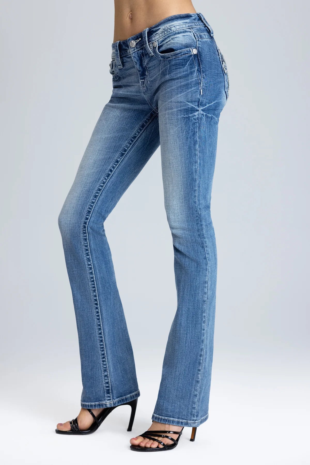 Blue jeans worn by a person on a white background