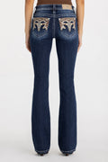 Blue jeans with decorative stitching on the back pockets against a white background