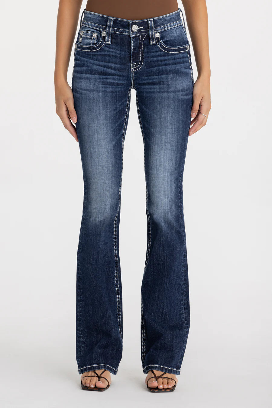 Blue jeans worn by a person on a white background