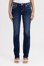 Person wearing dark blue jeans on a white background
