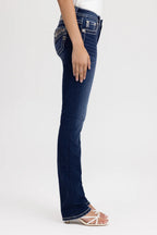 Person wearing dark blue jeans on a white background