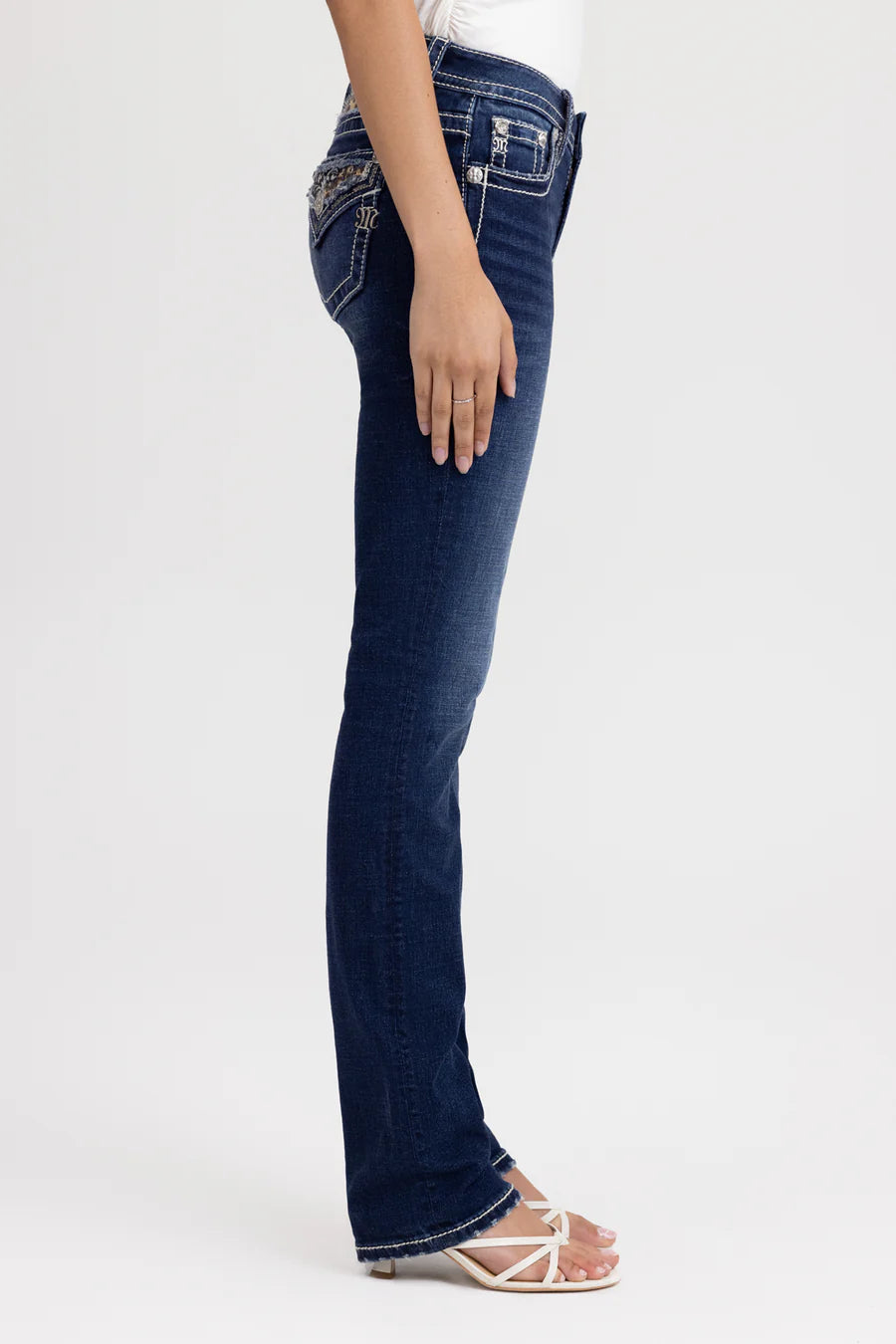 Person wearing dark blue jeans on a white background