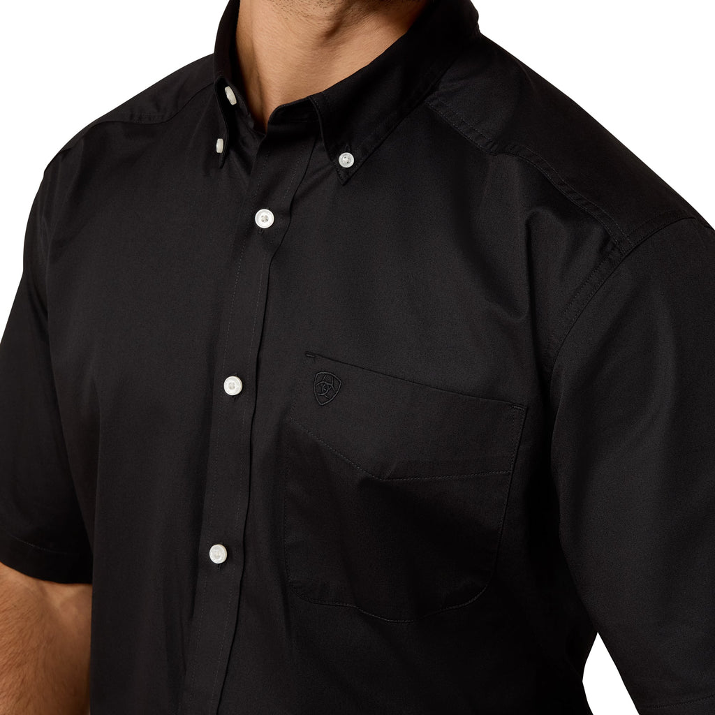 Black short-sleeve shirt with buttons on a white background