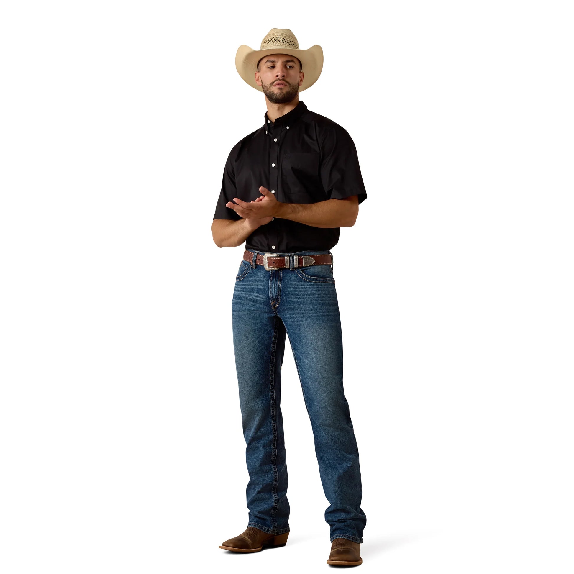 Man wearing a black shirt, blue jeans, and a straw cowboy hat on a white background