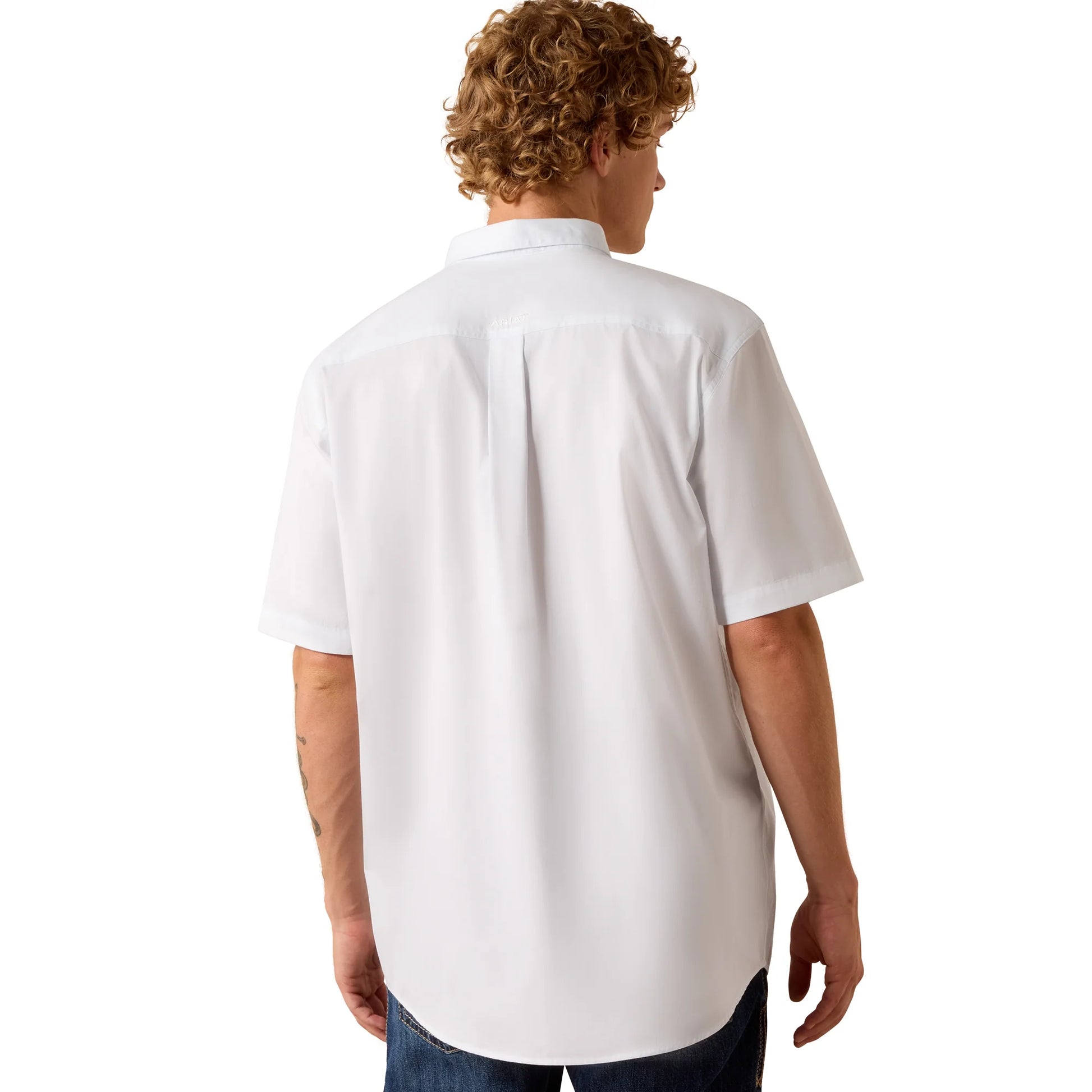 Person wearing a white polo shirt on a white background
