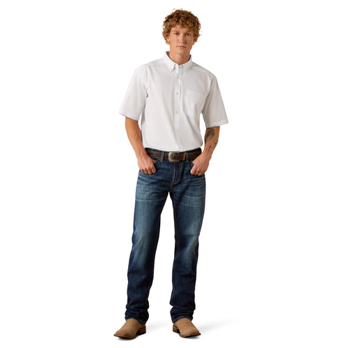 Man wearing a white shirt and blue jeans on a white background