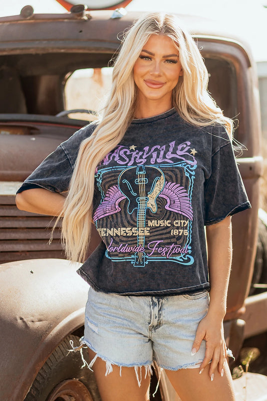 Woman wearing a graphic t-shirt in front of an old truck