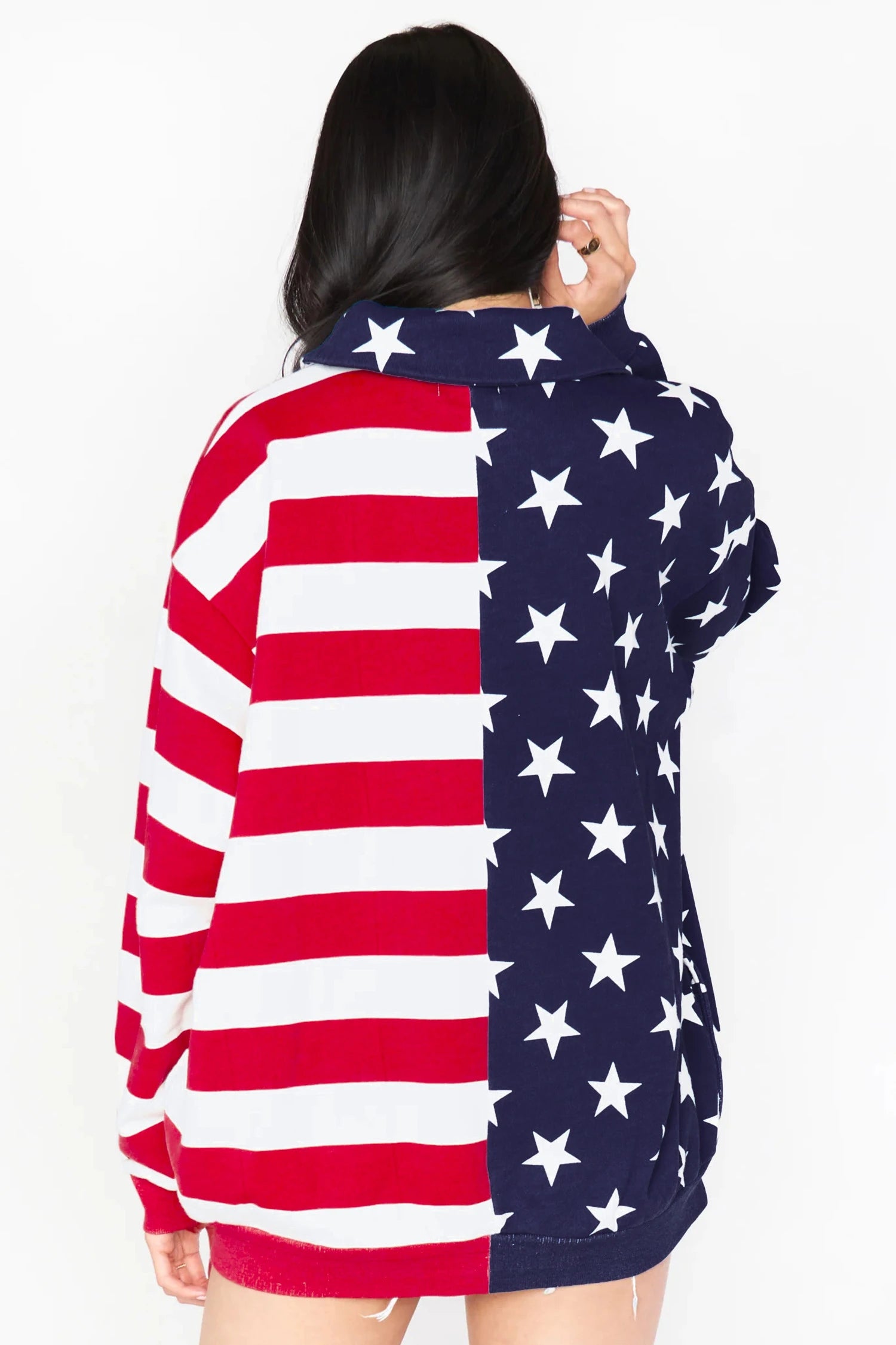 Person wearing a hoodie with an American flag design on a white background