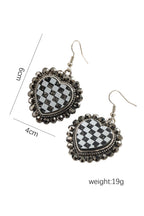 Pair of earrings with checkered design and measurements on a white background