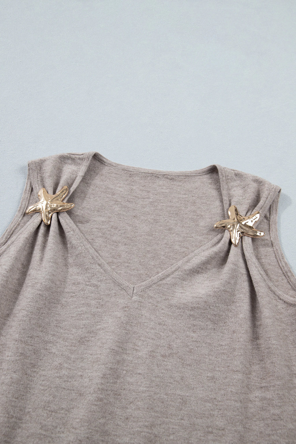 Gray sleeveless top with starfish designs on a light blue background