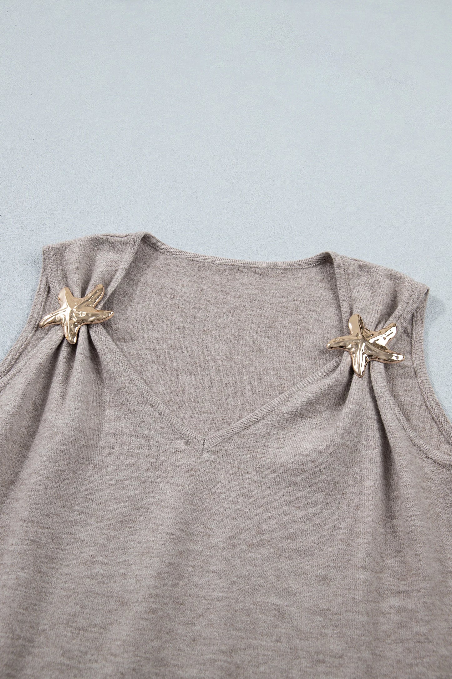 Gray sleeveless top with starfish designs on a light blue background