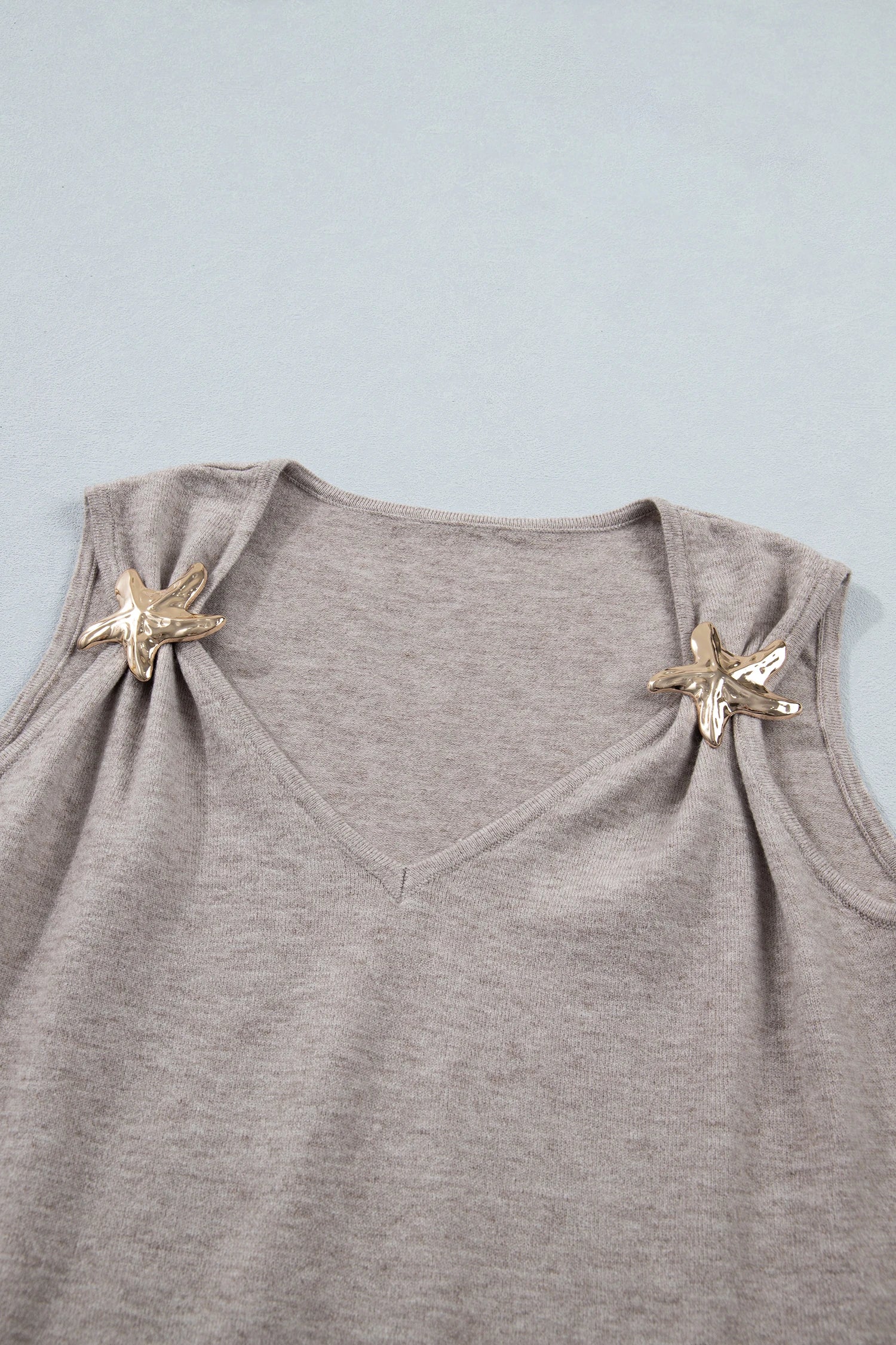 Gray sleeveless top with starfish designs on a light blue background