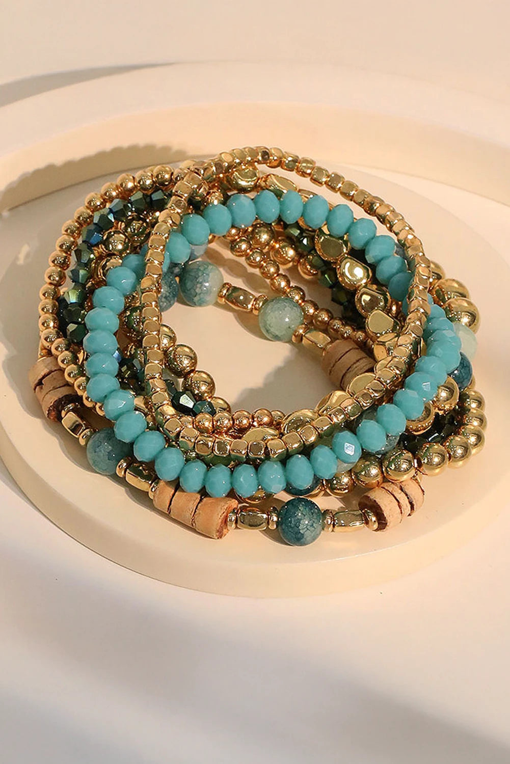 Stack of turquoise beaded bracelets on a white surface