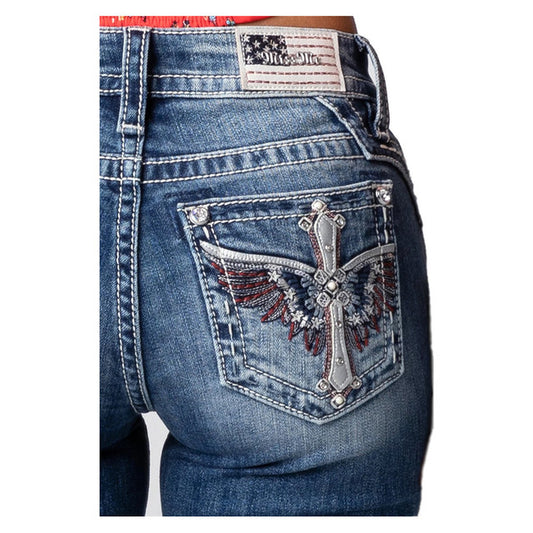 Blue jeans with decorative back pocket featuring a cross and wings design on a white background.