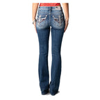 Person wearing blue jeans with decorative stitching on a white background